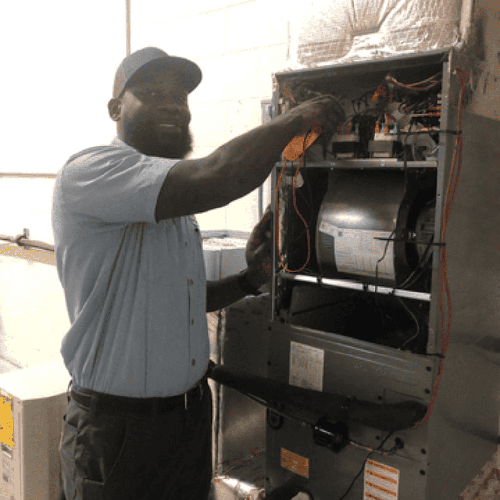 Devonte in front of an AC Designs van